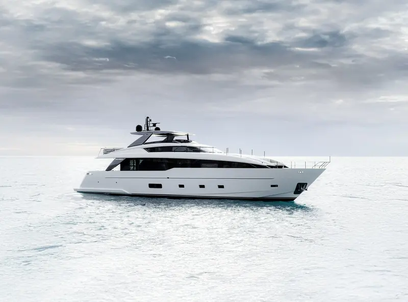 The Sanlorenzo SL86 Asymmetric underway on a flat, overcast sea, low profile and continuous glazing along the main deck.