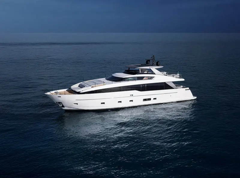 The SL86A at rest on a dark evening sea, reflections tracing the hull line.