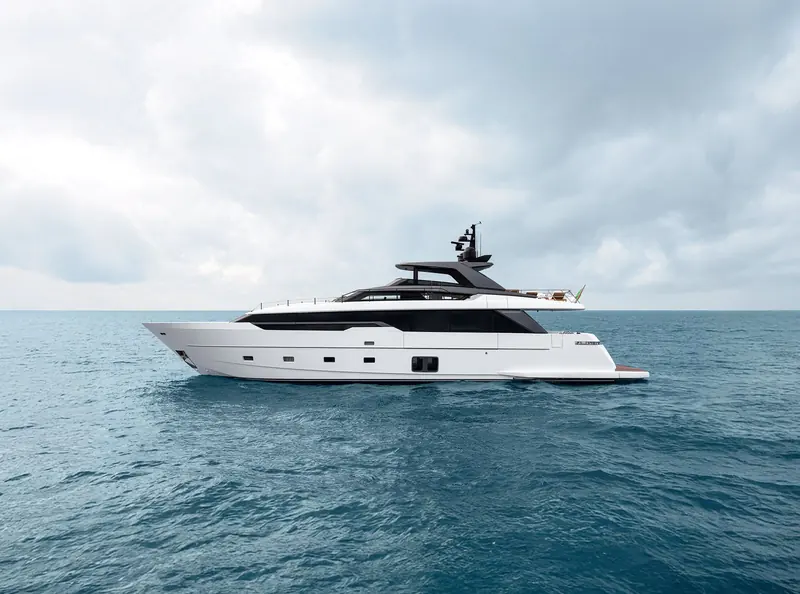 The Sanlorenzo SL96 Asymmetric at rest under a heavy sky, Sanlorenzo lettering visible on the hull.
