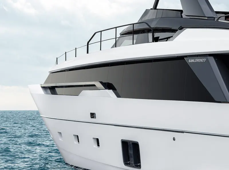 A close view of the flybridge and superstructure, showing the Sanlorenzo nameplate on the hull side.