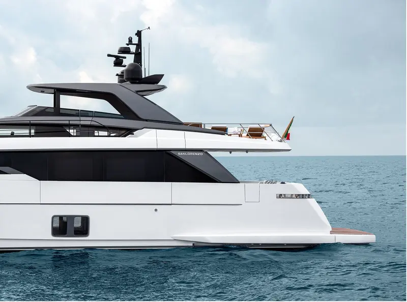 A three-quarter aft view showing the full asymmetric deck layout and open flybridge.