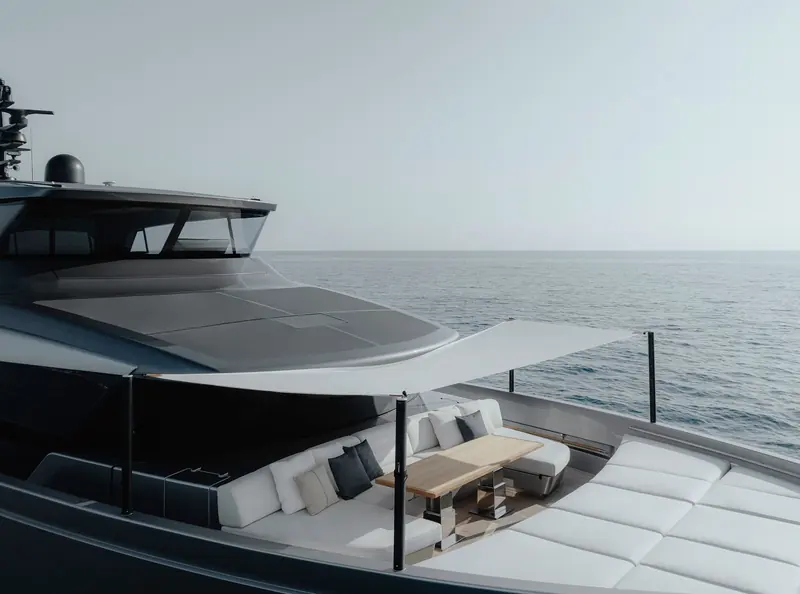 The flybridge lounge and helm area, open to the sky with wraparound seating.
