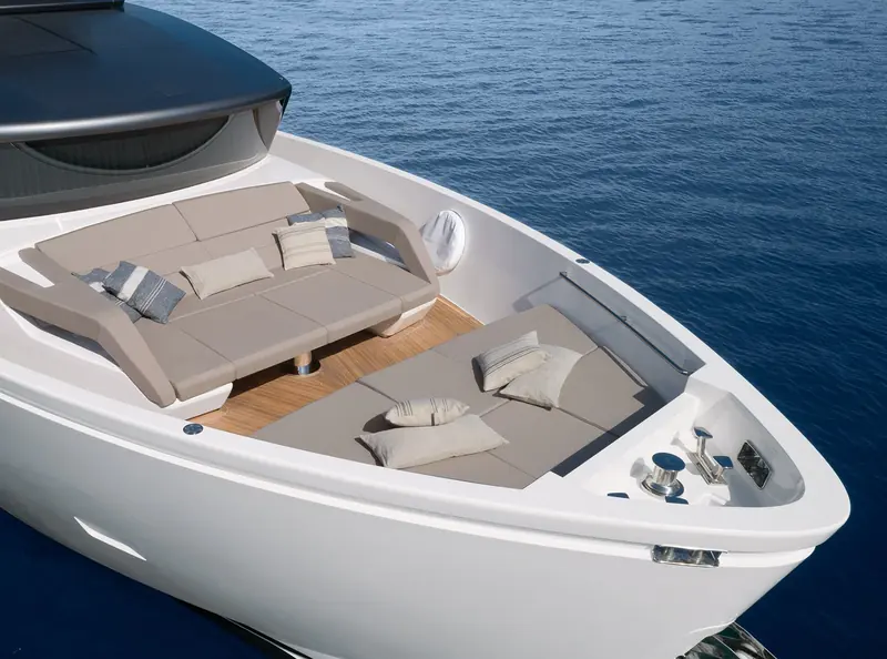 The foredeck lounge from above, deep cushioned seating built into the bow.