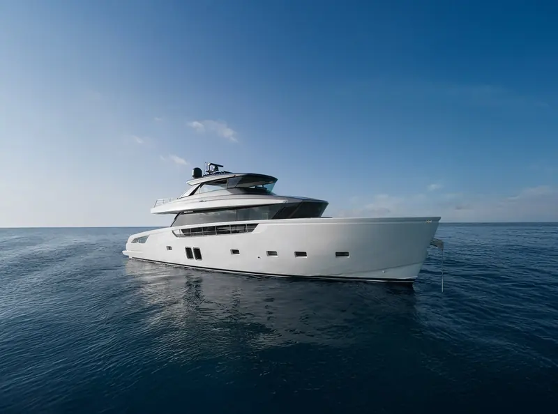 A broadside cruising shot against a clear sky, full profile from bow to stern.