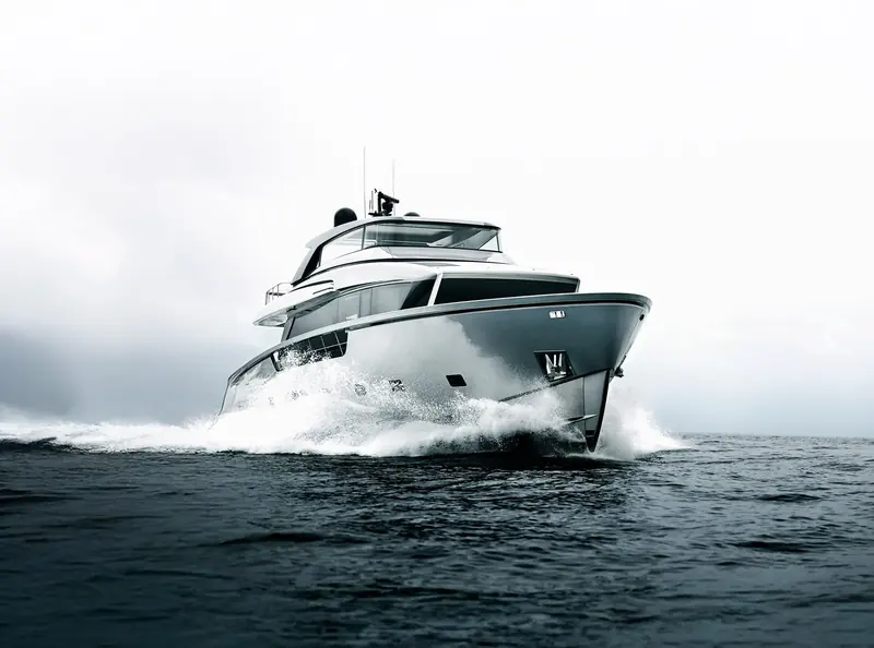 The Sanlorenzo SX88 planing hard, bow wave breaking clean either side of the crossover hull.