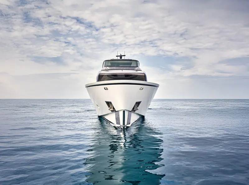 Bow-on view showing the SX88's reverse stem and reflection on a flat sea.