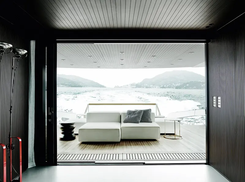 A lower lounge opening directly onto the swim platform and the water beyond.