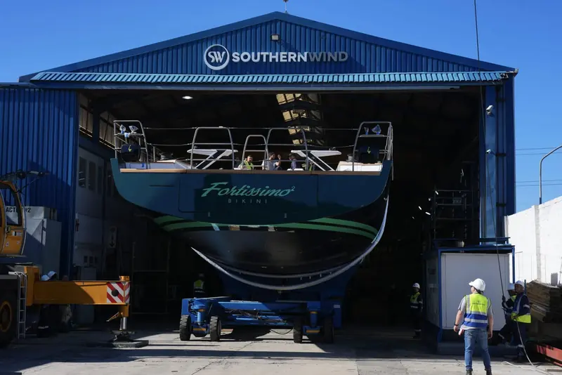 Fortissimo's dark green hull inside the shed at Southern Wind Shipyard, ready for launch.