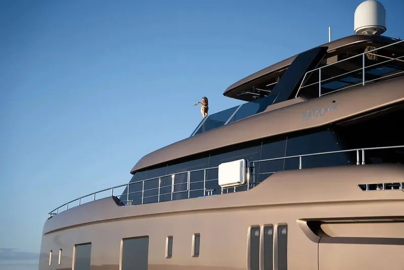 A close view of the flybridge coaming with the model nameplate, '100 Sunreef Power', cast into the hull side.