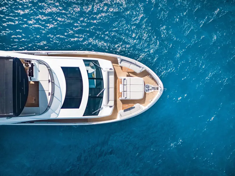 Looking straight down over the bow at anchor, the forward lounge, sunpads and jacuzzi-style plunge pool built into the foredeck sole.