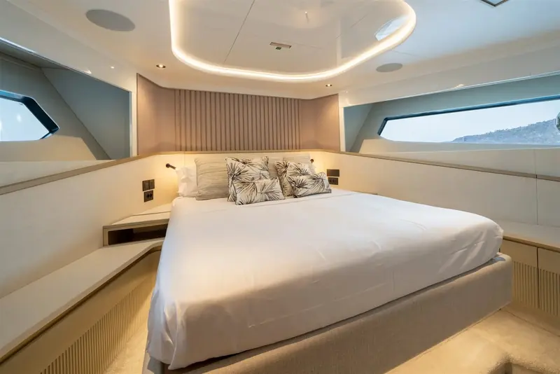 The forward cabin's angled hull windows and the recessed courtesy lighting are Sunseeker's current interior language, shared with the smaller Ocean-range boats.
