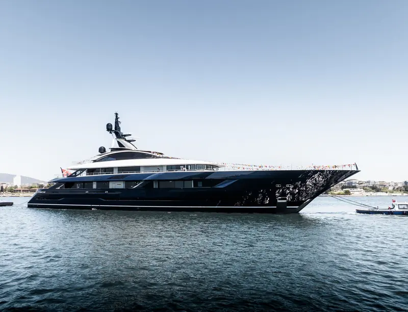 N2H, Turquoise Yachts' Project Arrow, at anchor in the Bosphorus shortly after her float-out, a tow boat standing by and signal flags dressing the sundeck rail.