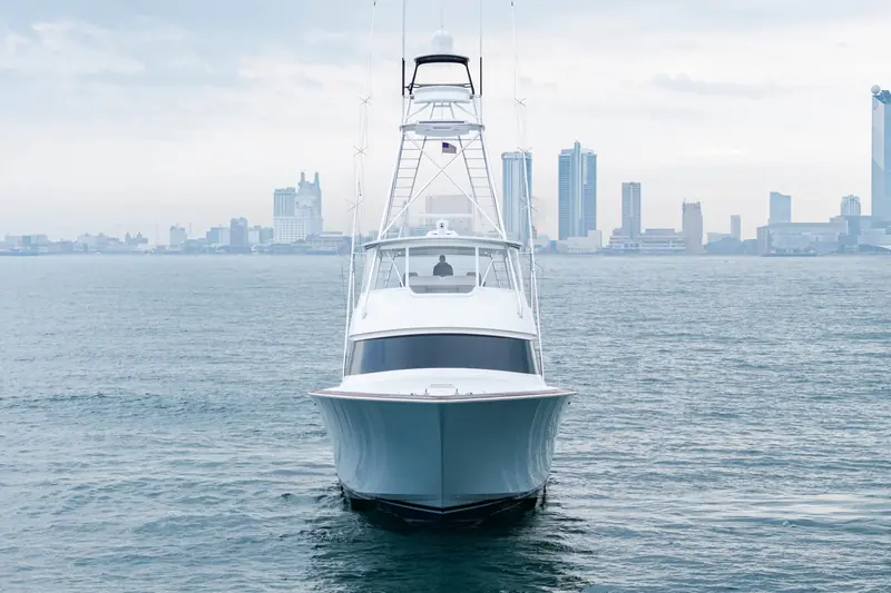 A Viking 82 Convertible head-on, the West Palm Beach skyline behind her.