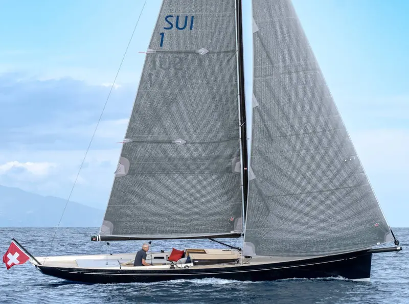 Under full main and genoa flying the Swiss SUI 1 sail number, the hull shows the plumb bow and low freeboard that keep the nano37 light and quick to tack.