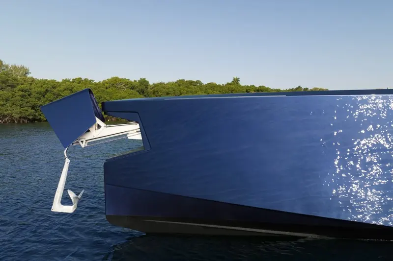 Detail of the hinged swim platform and outboard mounting, showing the transom engineering behind the X-series' outboard power.