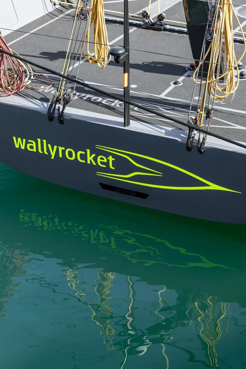 The "wallyrocket" script on the transom reflected in the water as the boat sits at rest, showing the model's yellow accent line.