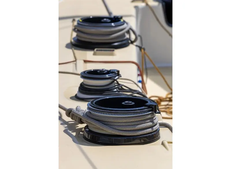 Deck hardware detail: the coachroof's coiled halyards and self-tailing winches used to trim the racing rig.