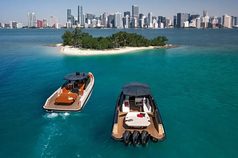 Two wallytenders rafted together off a small mangrove island, showing the model's proportions alongside a sister boat.