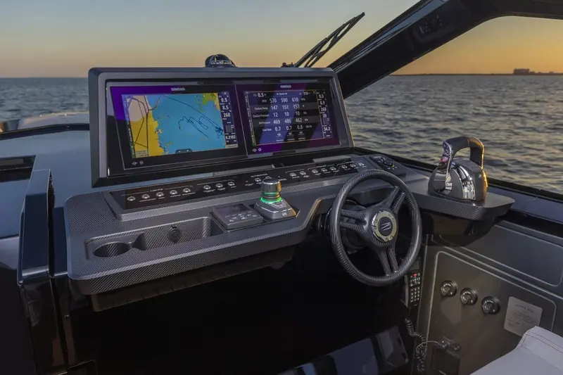 Helm and instrument console beneath the hardtop, wheel and throttles positioned for a single helmsman.