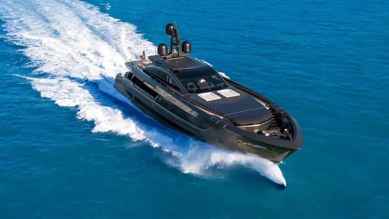 RUSH at speed off the Ligurian coast, her dark hull and central Voith waterjet throwing a single clean rooster tail behind the twin outboard wakes.