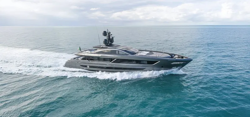 The 42 metre planing hull under way, low and dark against a bright sea, the shallow 2.10 metre draft that lets her into anchorages a deeper 40 metre yacht cannot reach.