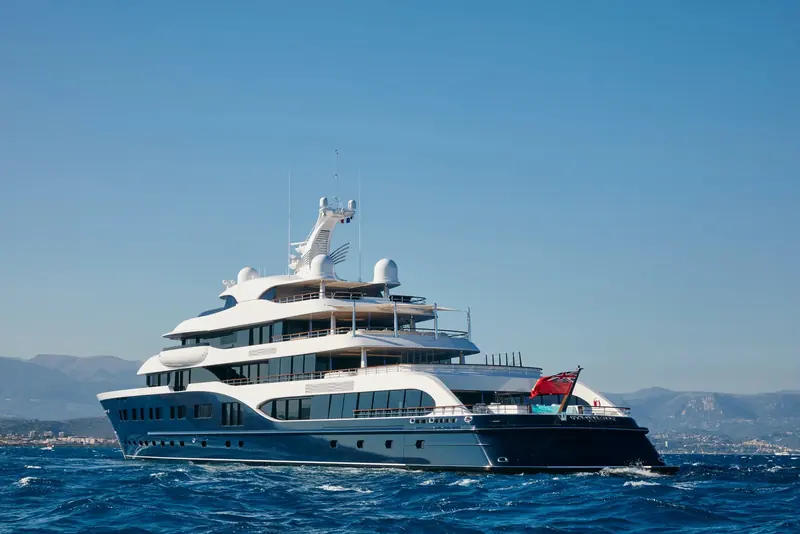 Symphony under way off the Cote d'Azur, the Red Ensign at the stern and the helideck's H marking visible on the foredeck.