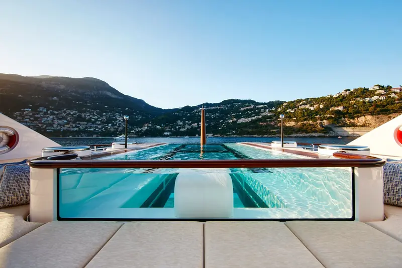 The glass-bottomed pool on the beach club deck, its window looking straight out through the transom at anchor.