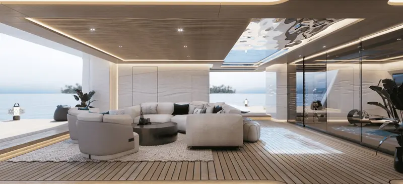 The beach club opens the full transom to the sea, with a glass-walled gym to starboard and a pool skylight overhead that doubles as a viewing panel from the deck above.