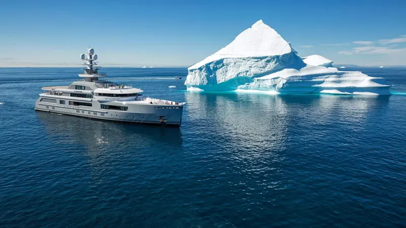 Cloudbreak dwarfed by a tabular iceberg in polar waters - the scale her explorer hull was actually built for.