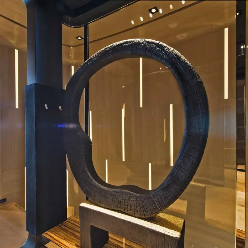 A sculptural ring installation set into the stairwell, part of an interior that leans into mountain-chalet materials rather than typical yacht gloss.