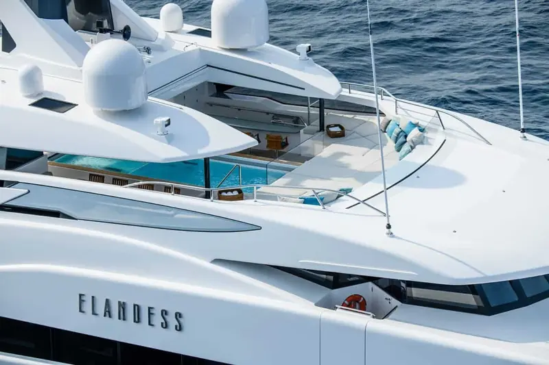 Elandess seen from above, her name lettered across the transom beneath the raised bow pool and sunpad.