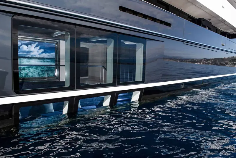The semi-submerged owner's suite windows sit partly below the waterline - one of Elandess's two engineering signatures, giving a fish-eye view straight into the sea.