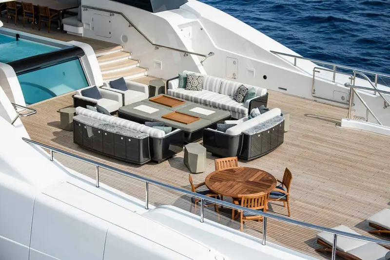 The aft deck lounge, teak decking and deep-seated furniture set up for outdoor living rather than formal entertaining.