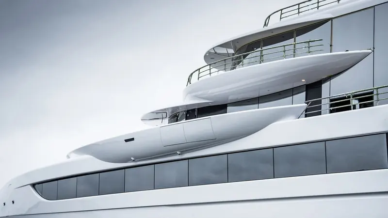 The reverse-raked bow decks that made Excellence impossible to mistake for another yacht - each level's overhang plunges forward past the one below it.