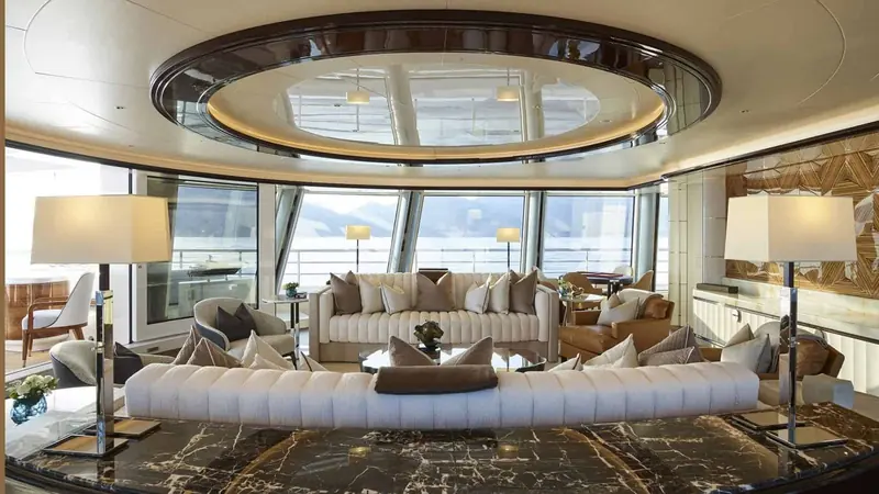 The main salon, sunken seating set into a circular lightwell beneath the deck above.