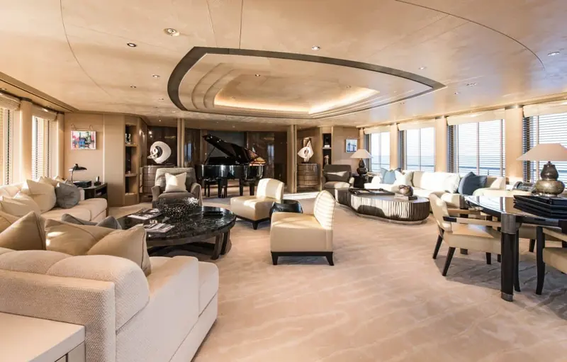 The main living room, dark marble flooring under a wraparound run of windows.