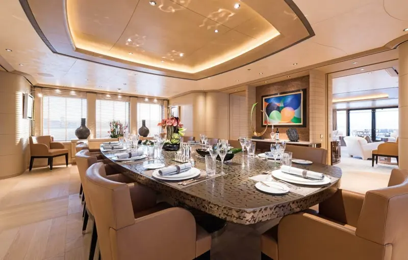 The formal dining room, its polished stone table set for a full complement of guests.