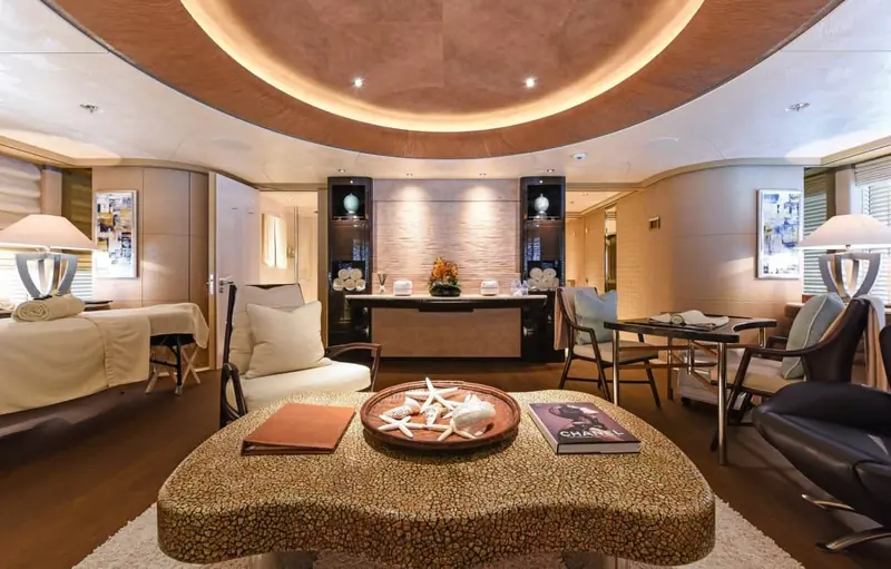The beauty and treatment room, a starfish tray and a stack of magazines on the table in front of the massage bed.