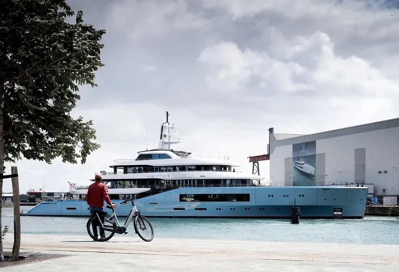 Dockside beside the yard, a passing cyclist giving an honest sense of scale that a running shot at sea never can.