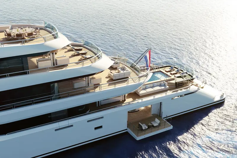 A straight-down aerial of the upper decks shows the sundeck dining table forward, a spa pool and lounge amidships, and a separate sofa aft, three distinct outdoor rooms stacked on one deck.