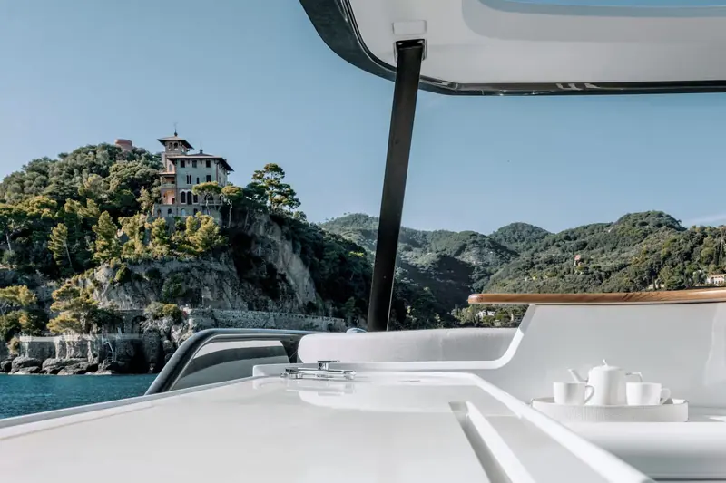 The view from the flybridge helm toward Portofino's harbourside villas - the kind of arrival the Fly 68 is built for.