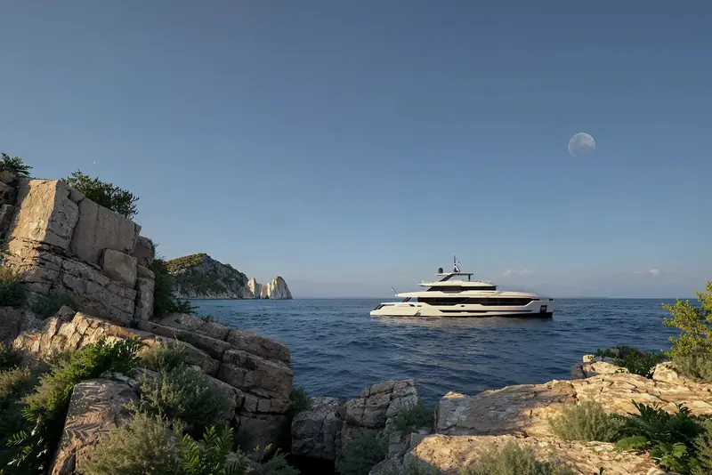 DOM133 anchored off Capri's Faraglioni stacks at moonrise, the raked reverse bow of the DOM line silhouetted against the last of the evening light.