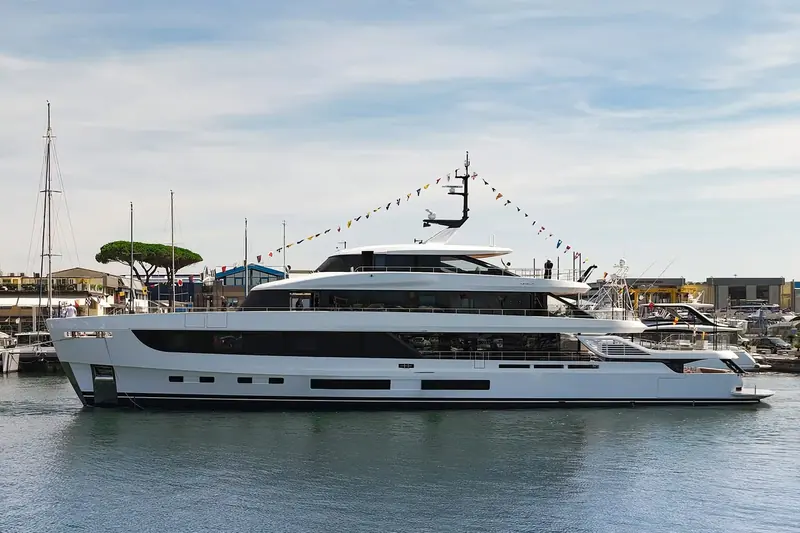 Grande 44M dressed overall with signal flags at her berth, other yachts crowding the marina behind her.
