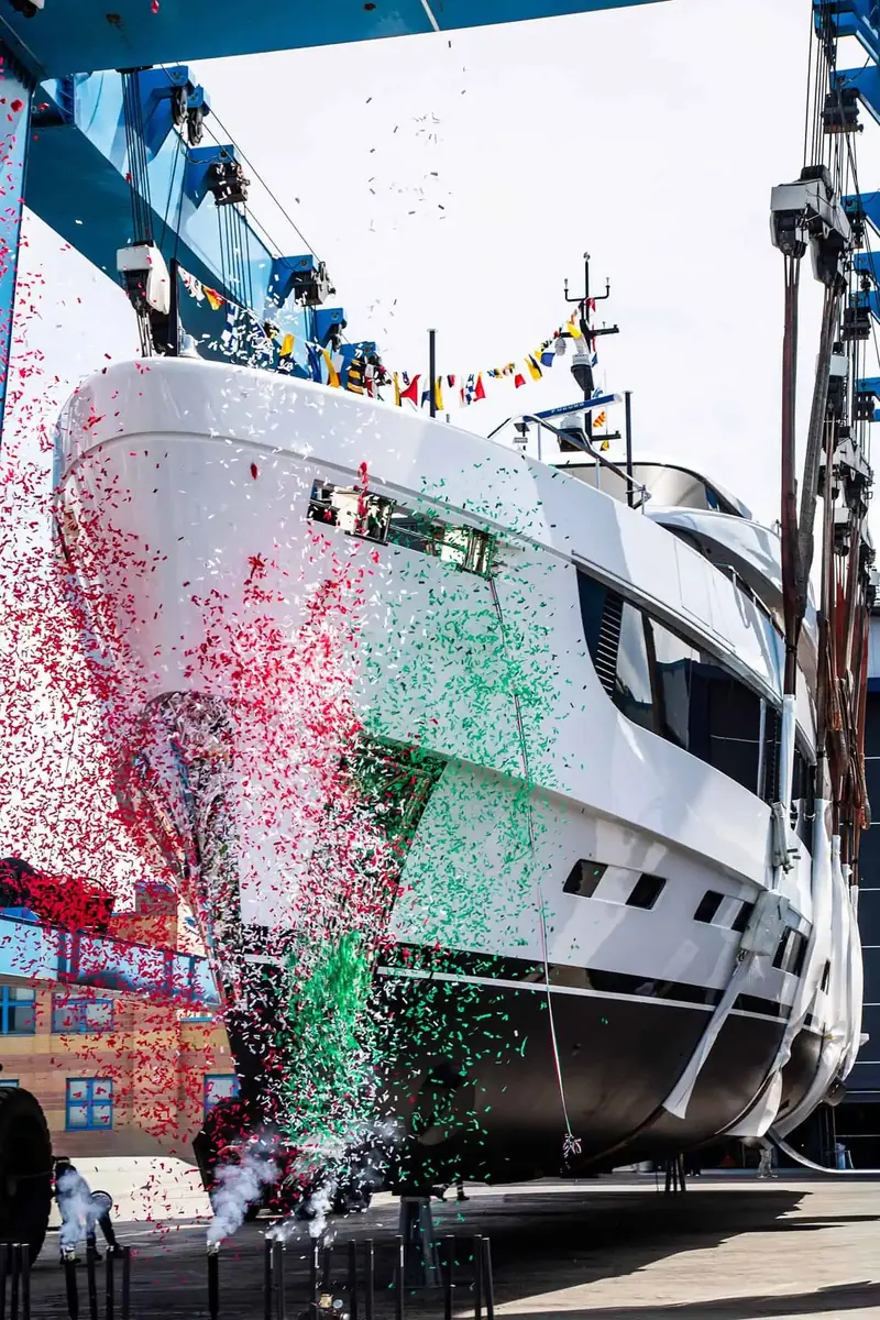 Tricolore confetti bursts across the bow at the moment of christening.