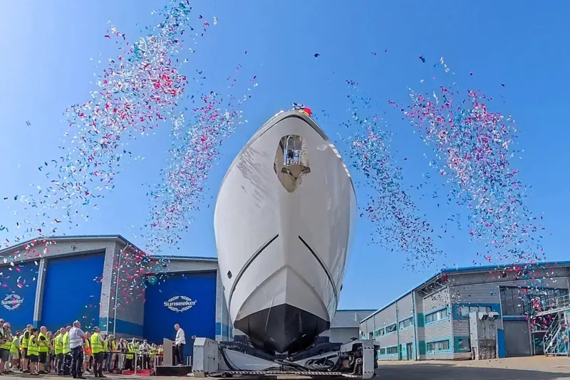Hull one of the Manhattan 94 clears the shed doors under a burst of confetti at Sunseeker's Poole yard, the first of the model to touch water.