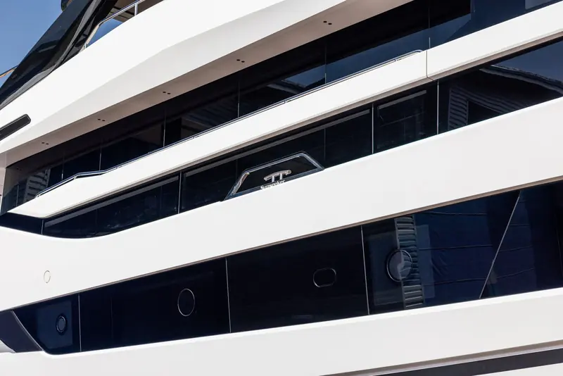 A close look at the hull glazing shows the raked deck lines and the Sunseeker badge set into the side window mullion.
