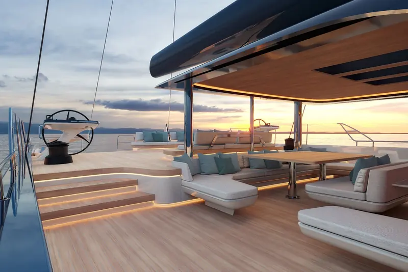 A wraparound aft-deck lounge and dining area on the Swan Alloy 44, lit at dusk.