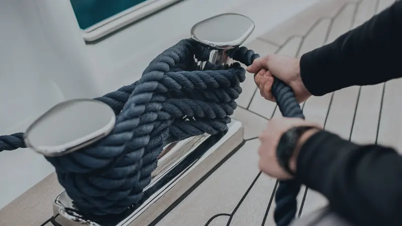 A crew member secures dock lines aboard a superyacht - the image Acquera Group published with its own announcement of the Wilsonhalligan acquisition.