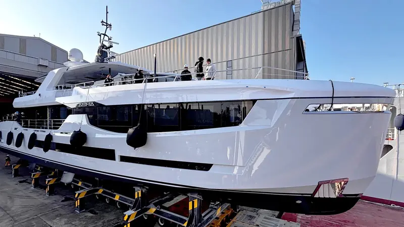 Aisha on her transport cradle at Anadolu Shipyard's Tuzla facility, the AISHA nameplate visible on the hull ahead of her first launch.