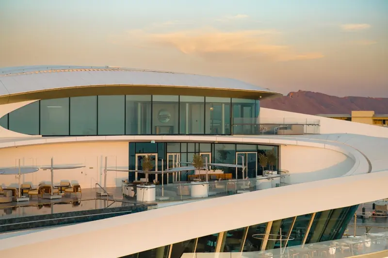 A rooftop terrace at AMAALA Yacht Club, with the Hijaz Mountains behind